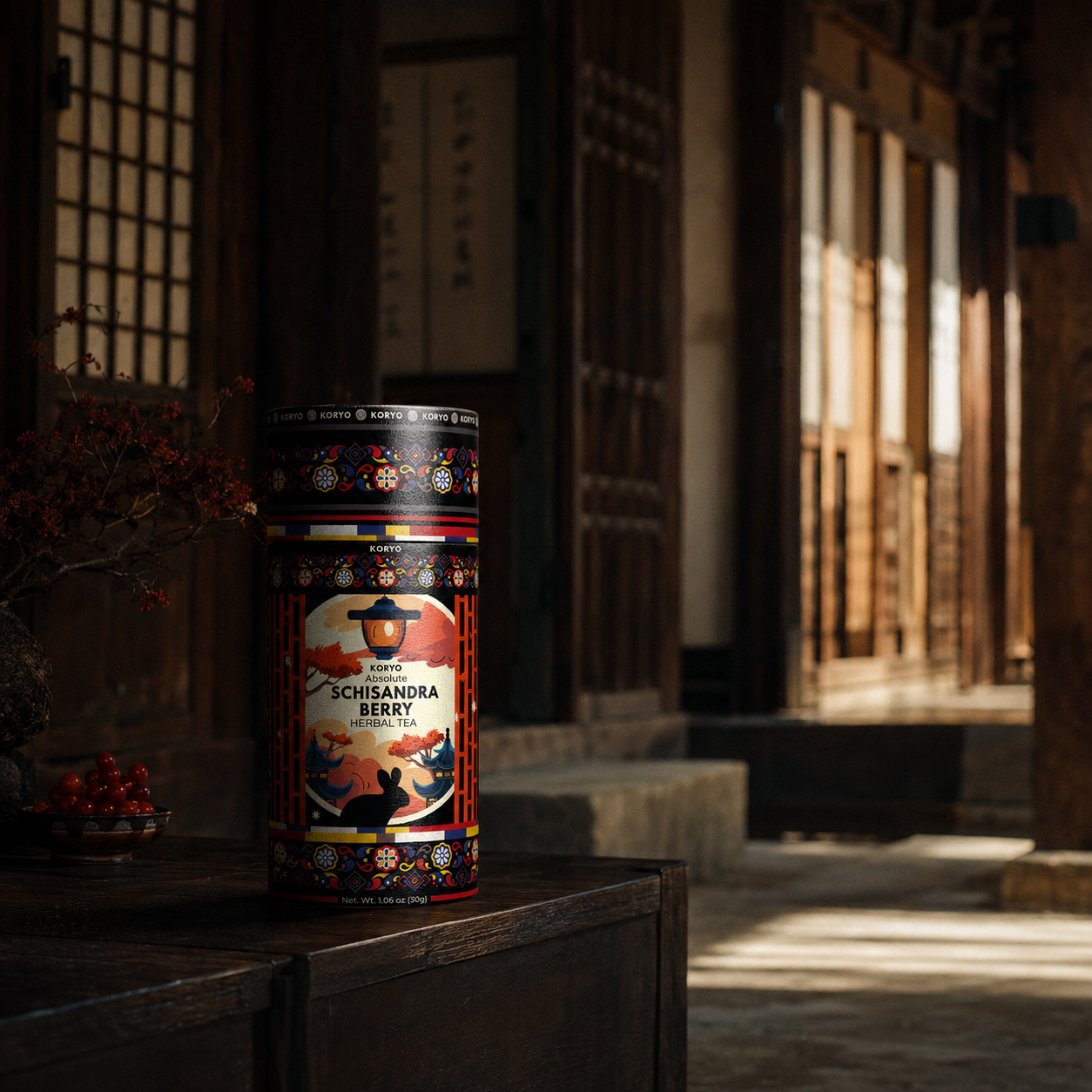 KORYO Schisandra Berry Herbal Tea packaging displayed with red berries in a warm Korean-inspired architectural interior.
