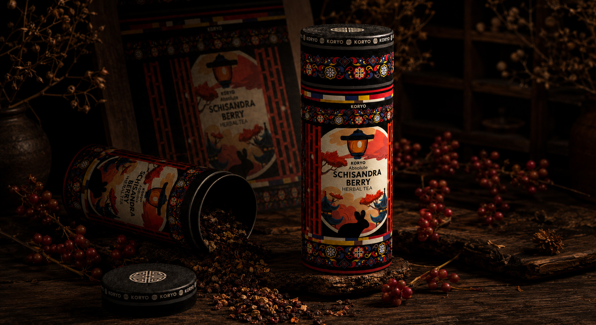 KORYO Schisandra Berry Herbal Tea canisters displayed with loose herbal tea, red berries, a branded lid, and framed packaging artwork.